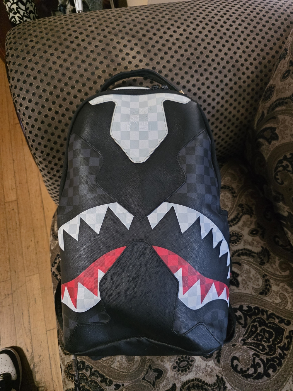 Sprayground Black Checker Shark-Mouth Backpack with White and Red Accents
